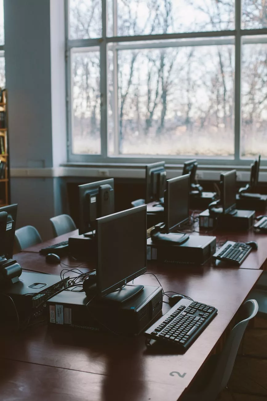 photo of computers near windows